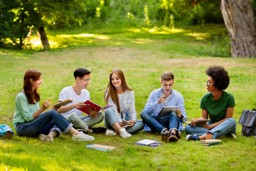 Education Concept. Group of multiethnic students preparing for lectures together outdoors