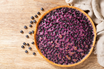 Fototapeta na wymiar blueberry pie and fresh berries, top view
