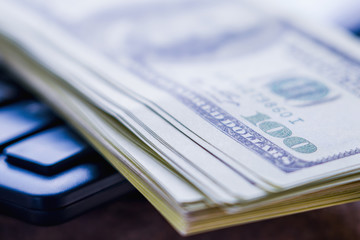 Business and money concept. Close up US Dollar bills and calculator