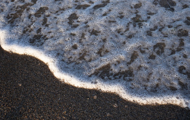 Calm wave on the sand on the beach