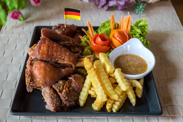 Pork hock in German with sauces delicious food. Deep fried pork knuckle ,Thai style serve with seafood sauce. Crispy pork knuckle or German Pork Hocks on wood board.