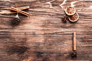Christmas wooden background with cinnamon sticks, pine cones and anise. Merry Christmas Happy New Year concept. Copy space.