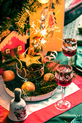 Christmas romantic evening. Glasses of wine on a festively served table.