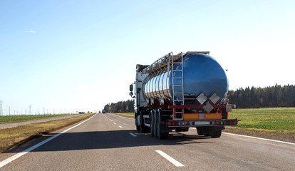 Tanker truck transporting bulk cargo on the highway, industry. Concept for the transportation of...