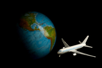business trip concept. airplane on a black background on a background of the globe. flight to any point of the world