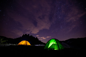 Tents in the night with the milky way. Wanderlust concept. 
