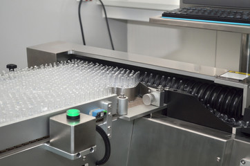 Ampoules with medicine in the production of an automated line pharmaceutical factory