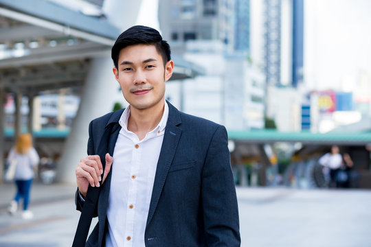 A young cinfident businessman smiling in the city Concept business man
