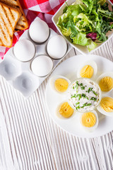 boiled chicken eggs on a white wooden rustic background