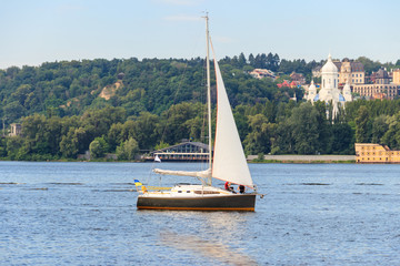 White modern sailboat sailing on the Dnieper river in Kiev, Ukraine