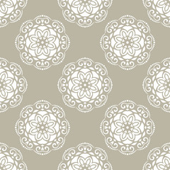 Floral vector white ornament. Seamless abstract classic background with flowers. Pattern with repeating floral white elements. Ornament for fabric, wallpaper and packaging
