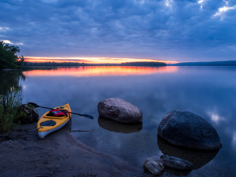yellow kayak on the lake at sunrise