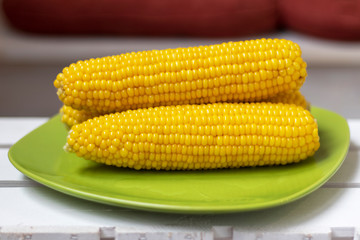 Boiled Sweet Corn On Green Plate On Wooden Table.