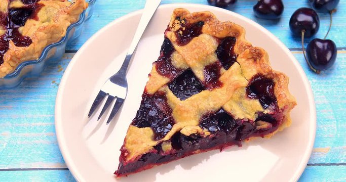 Delicious homemade cherry pie features a buttery flaky pie crust and juicy cherry filling. Dessert ready to be served. 4k