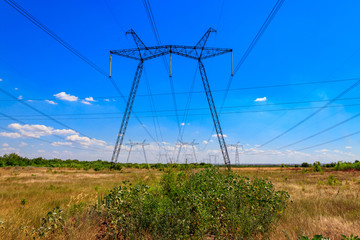 High voltage power line against blue sky