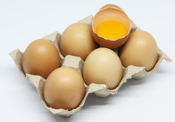 six eggs and yolk on white background