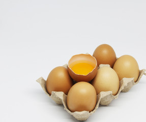 six eggs and yolk on white background