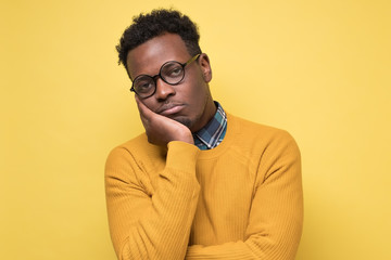 Unhappy frustrated young african man having puzzled expression