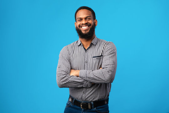 Smiling afro man posing on blue background