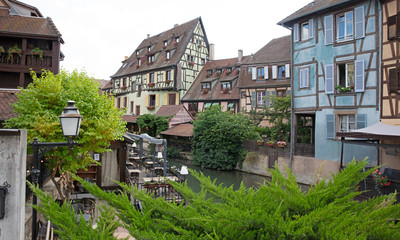 Fototapeta na wymiar Colmar, France on july 20, 2020; Petite Venice, water canal and traditional half timbered houses. Colmar is a charming town in Alsace, France.