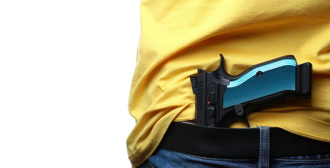 Man conceal carry pistol in jeans isolated on white background
