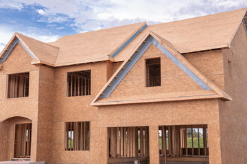 the house has been framed and covered in plywood construction new