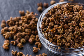 Sichuan pepper on a dark stone background