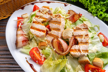 Caesar salad on dark wooden rustic background