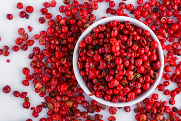 fragrant pink peppercorns on white acrylic background