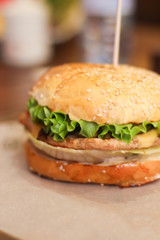 Burgers with lettuce, cutlet and tomatoes. Burgers in the restaurant. Burgers close up. Fast food, wrong food. Fat. Obesity