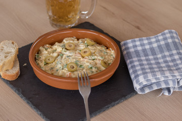 Plato de ensaladilla rusa en una bandeja de pizarra