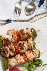 Grilled vegetables with chicken kebabs top view