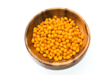 Sea-buckthorn berries in glass bowl on a white background. Top view.