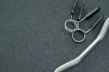 Two barbell clamps and a barbell fragment on a rubber floor in a fitness room. Background for fitness, place for text.