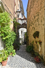 Fototapeta na wymiar A narrow street among the old houses of Lenola, a medieval village in the Lazio region.