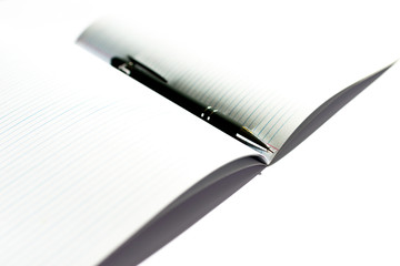 Top view of opened notepad with black pen white background. Mockup for your banner. Flat lay.