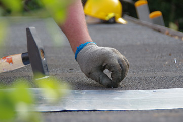 Nailing nails with a hammer in hand