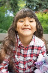 Portrait of a cute happy girl hugging plush toy