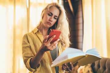 Woman with diary using smartphone