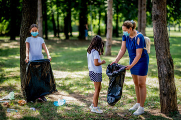 School children picking up garbage together while cleaning public park