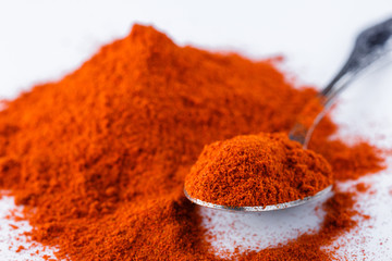 fragrant ground paprika on a white acrylic background