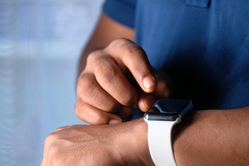 top view of man's hand using smart watch.