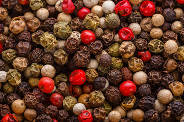 mix of peppercorns on white acrylic background