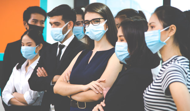 group of diversity business people wearing protective medical masks for protection from virus in office