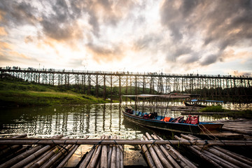 
In the evening, the tourist boat pier sees an ancient wooden bridge, Sangkhla Buri District, Thailand