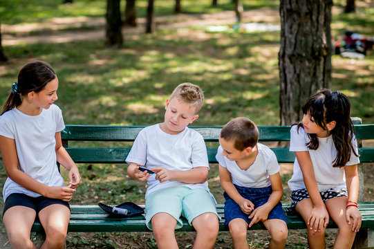 School Boy With Diabetes Testing His Blood Sugar After Physical Education, Friends Support Him.