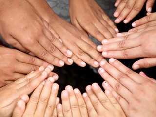 Hands of children held together, high angle view