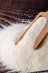 natural organic semolina on dark wooden rustic background