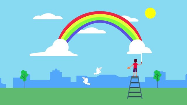 Little boy draws and paints rainbow in blue sky