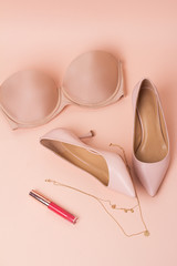beige lingerie shoes, lip gloss and jewelry.